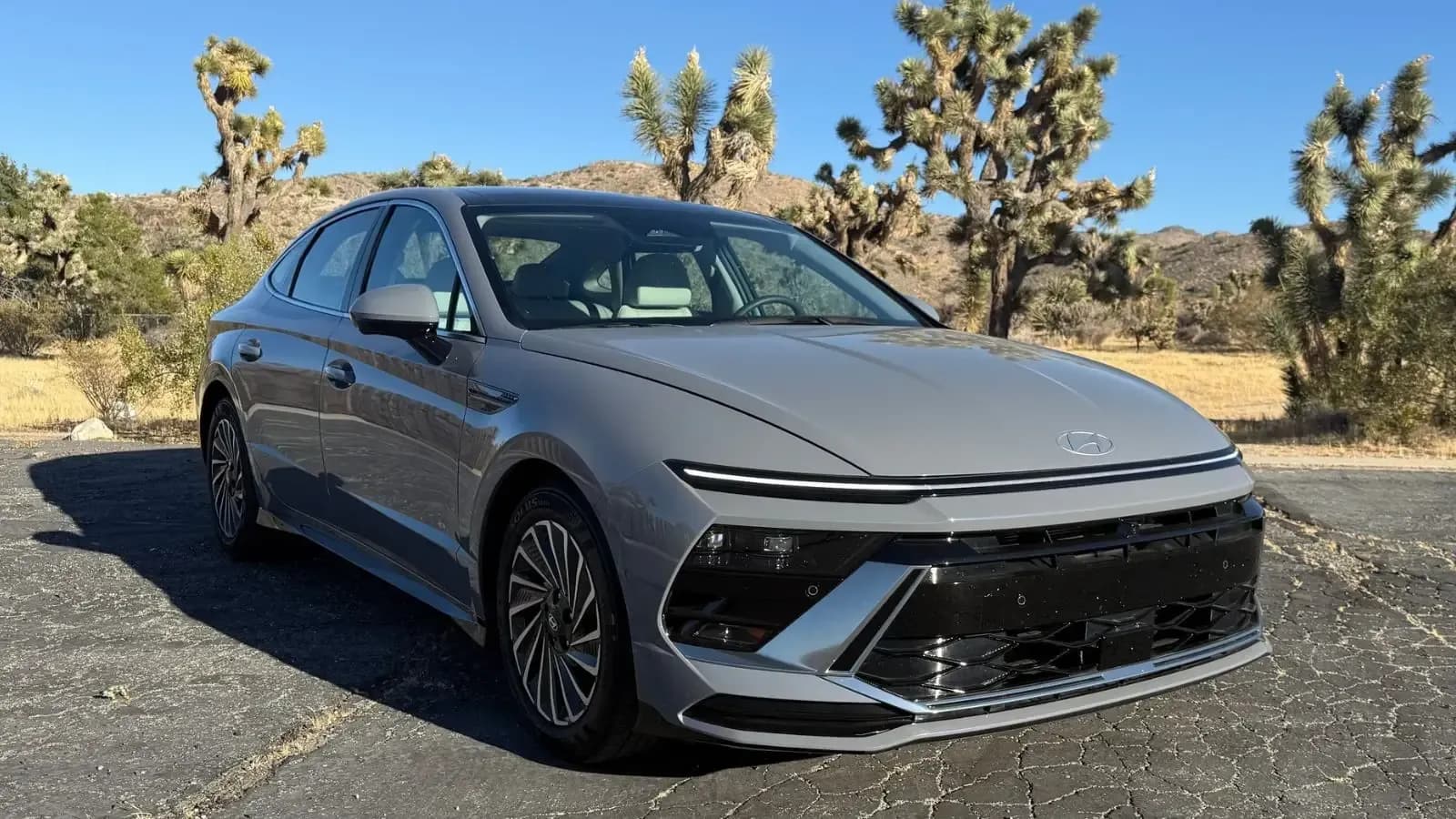 Grey Hyundai Sonata parked in front of a desert setting