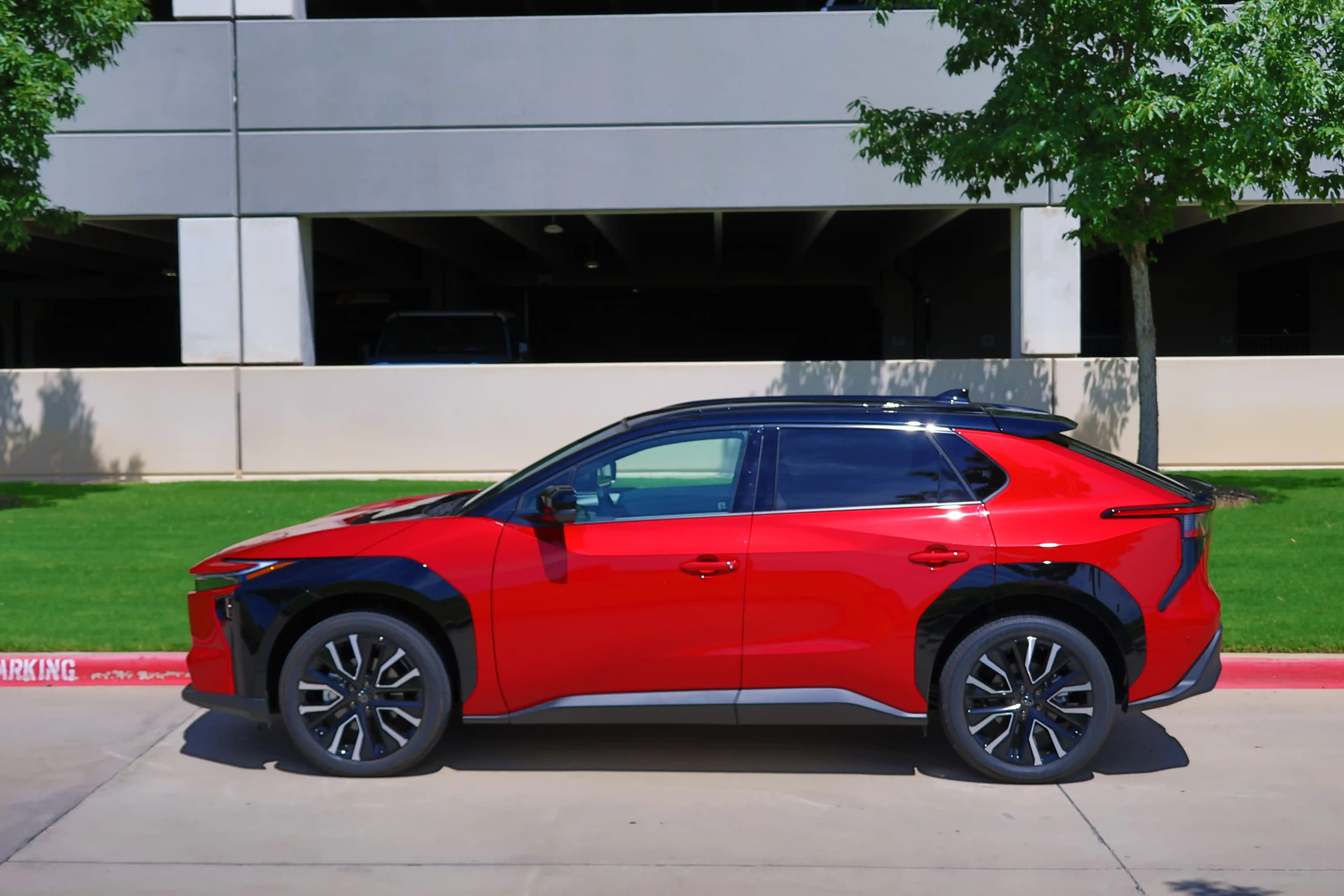 A red 2027 Toyota bZ side profile photo