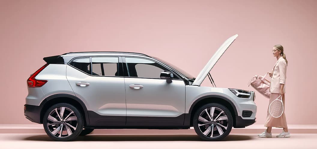 Woman with Volvo XC40 Recharge loading front trunk for tennis practice