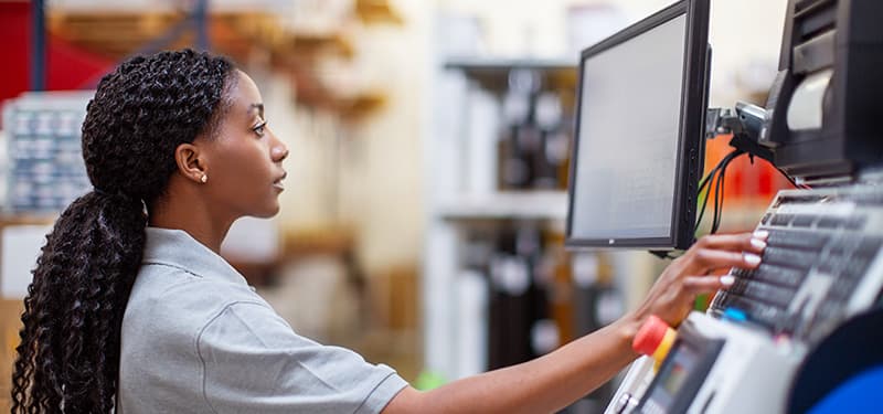 Female mechanic looking at computer