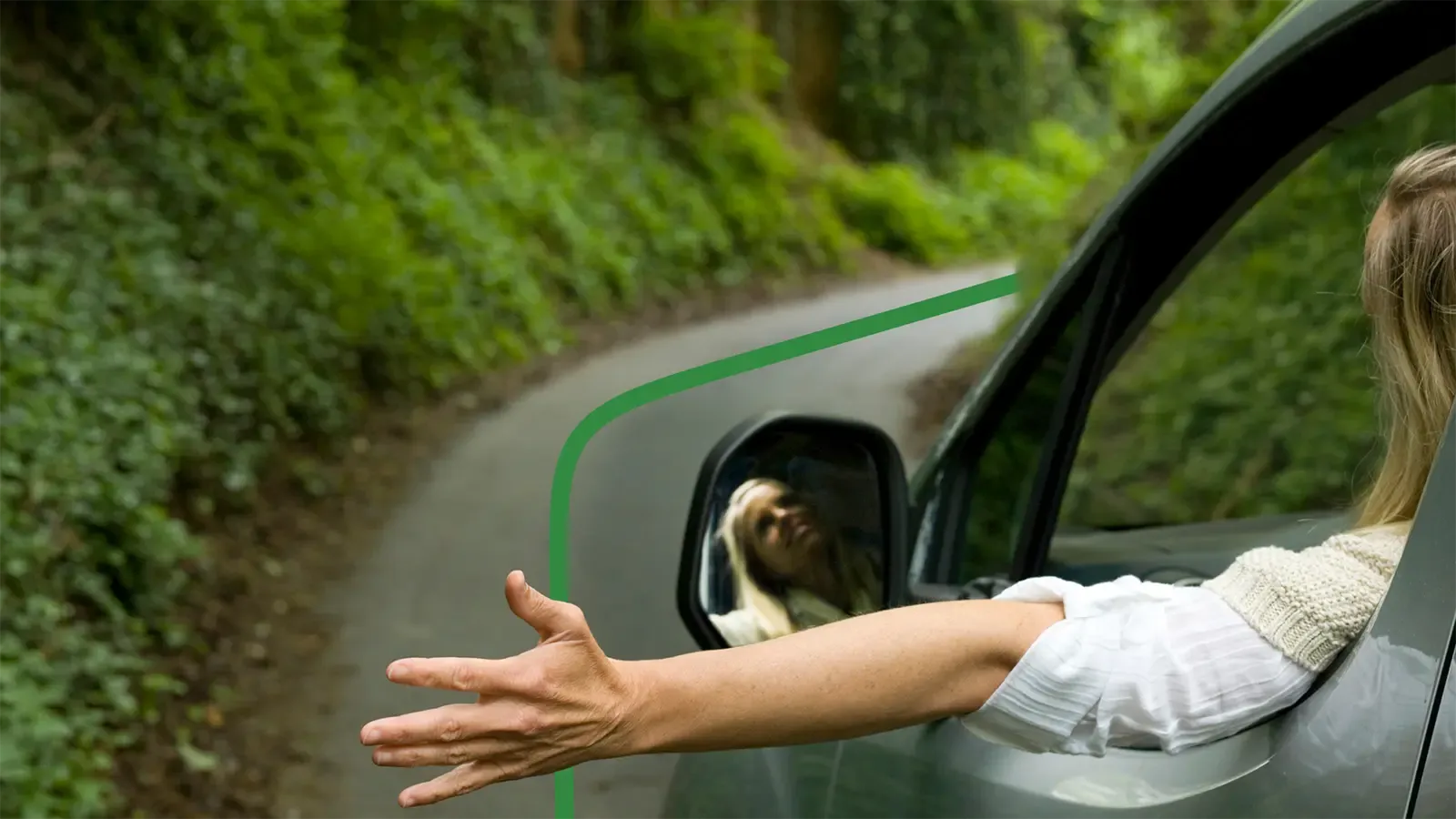 Driving through trees with hand out window