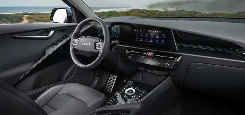 Kia Niro Hybrid interior steering and tech overlooking beach