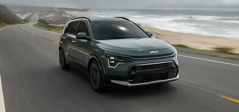Kia Niro Hybrid Driving Past the Beach