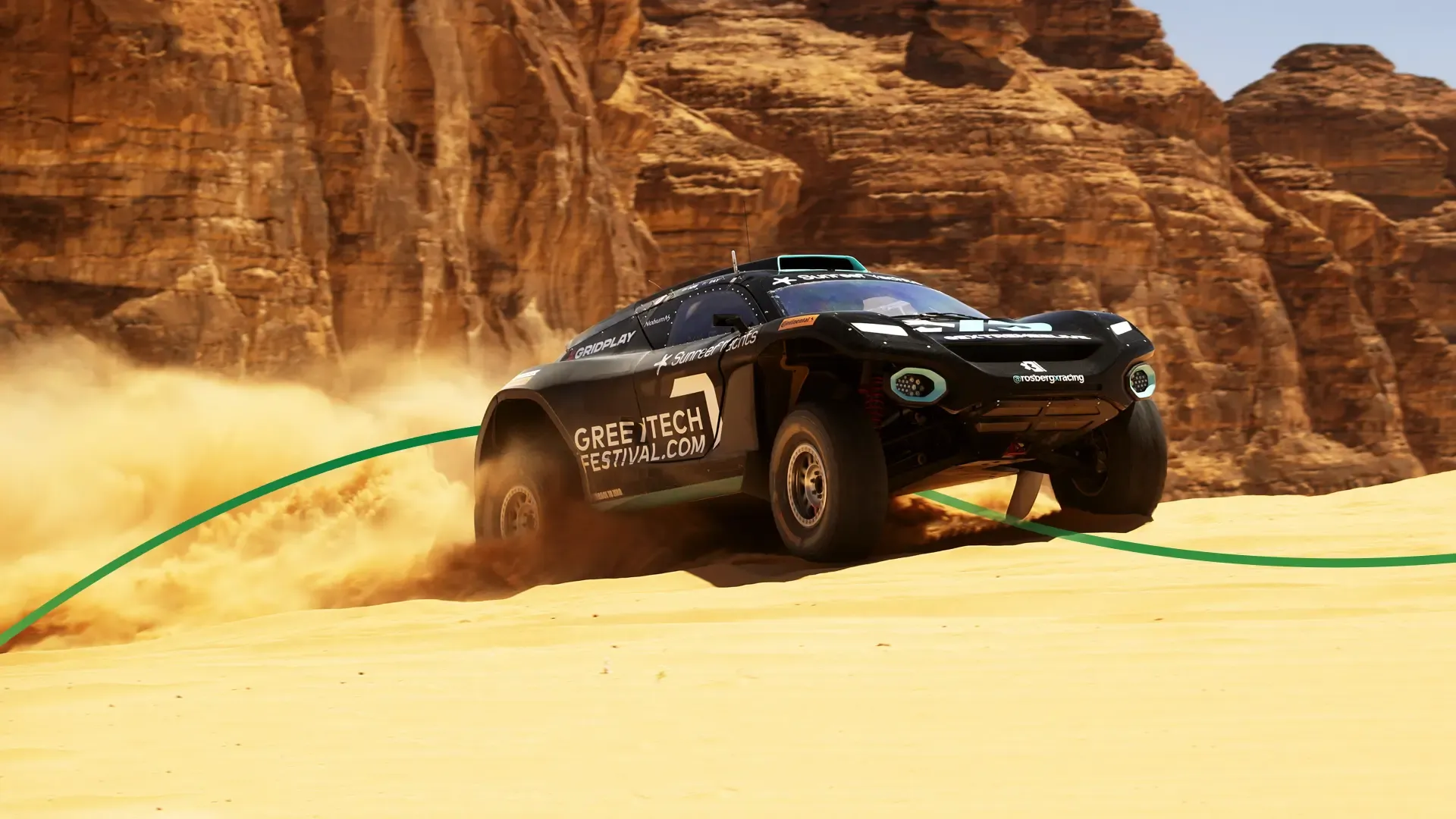 Black Electric car revving up a sand dune
