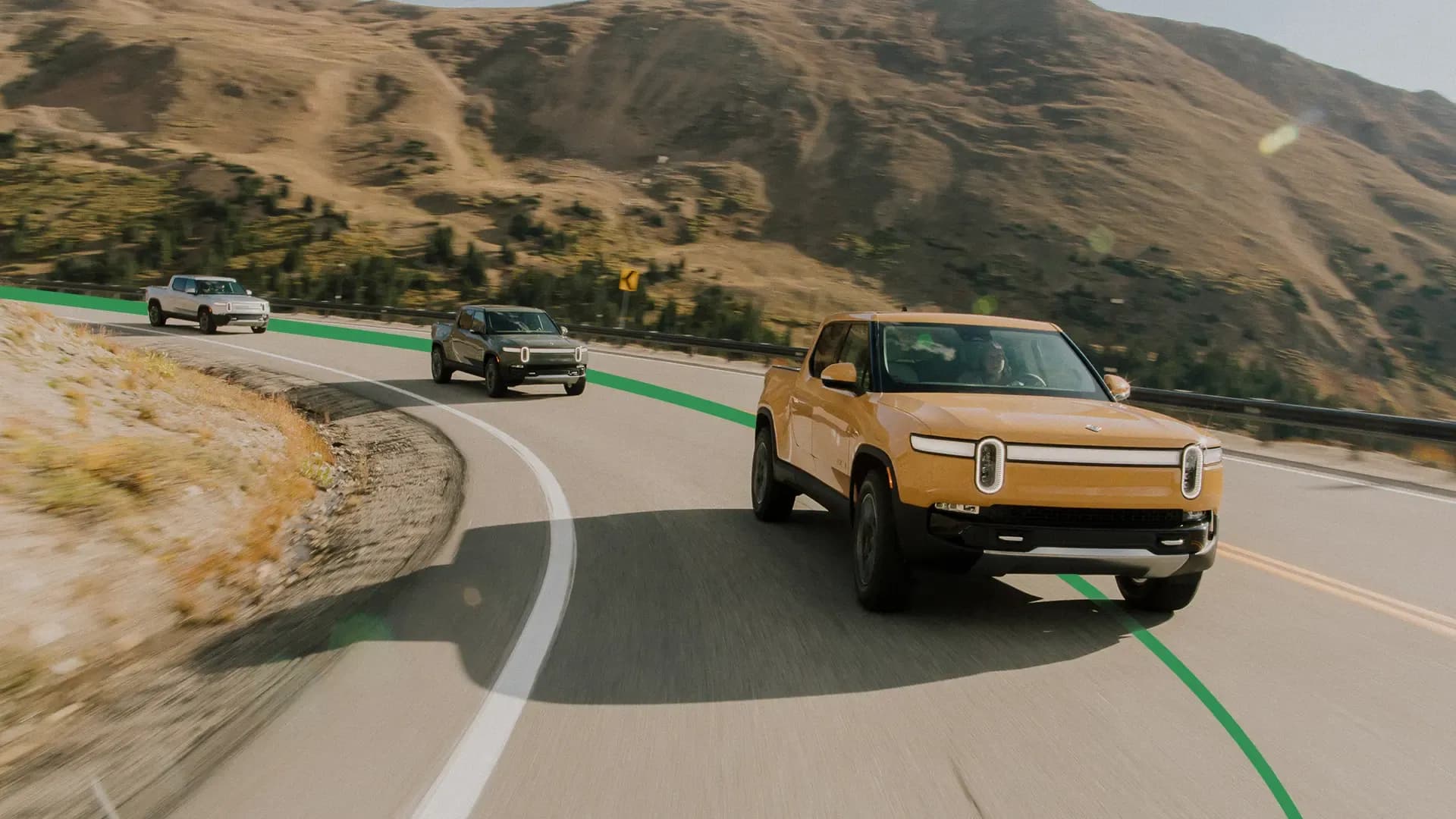 Rivian R1Ts driving through canyons