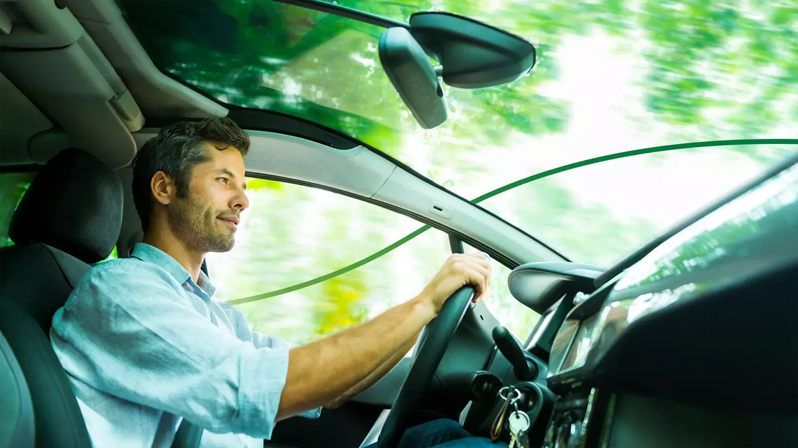 Man smiling while driving an EV