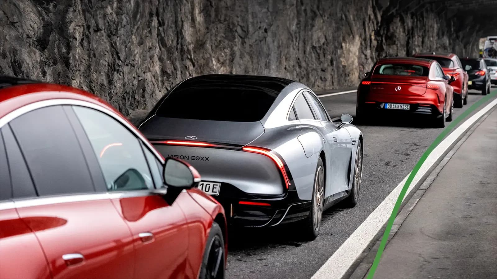 EQXX driving a mountain road with outher Mercedes-Benz models