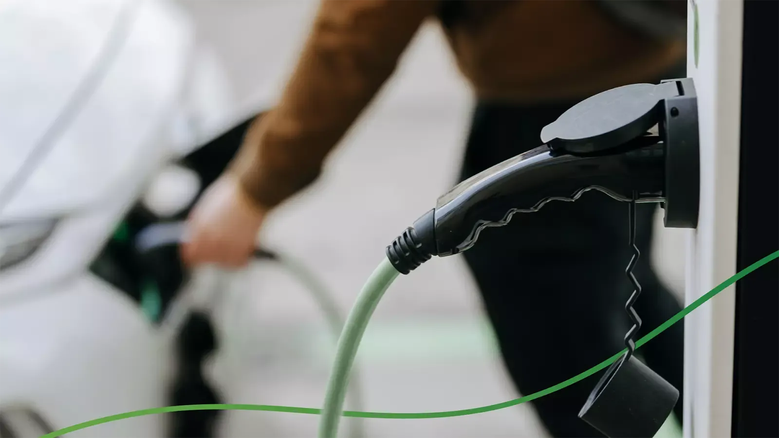 man charging ev