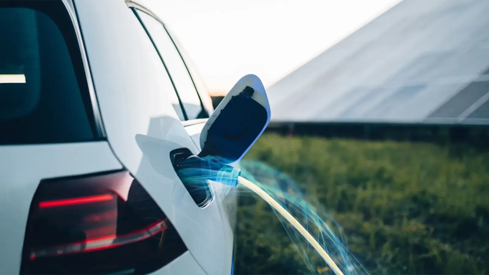 EV charger plugged into car, with blue and green motion lines around it
