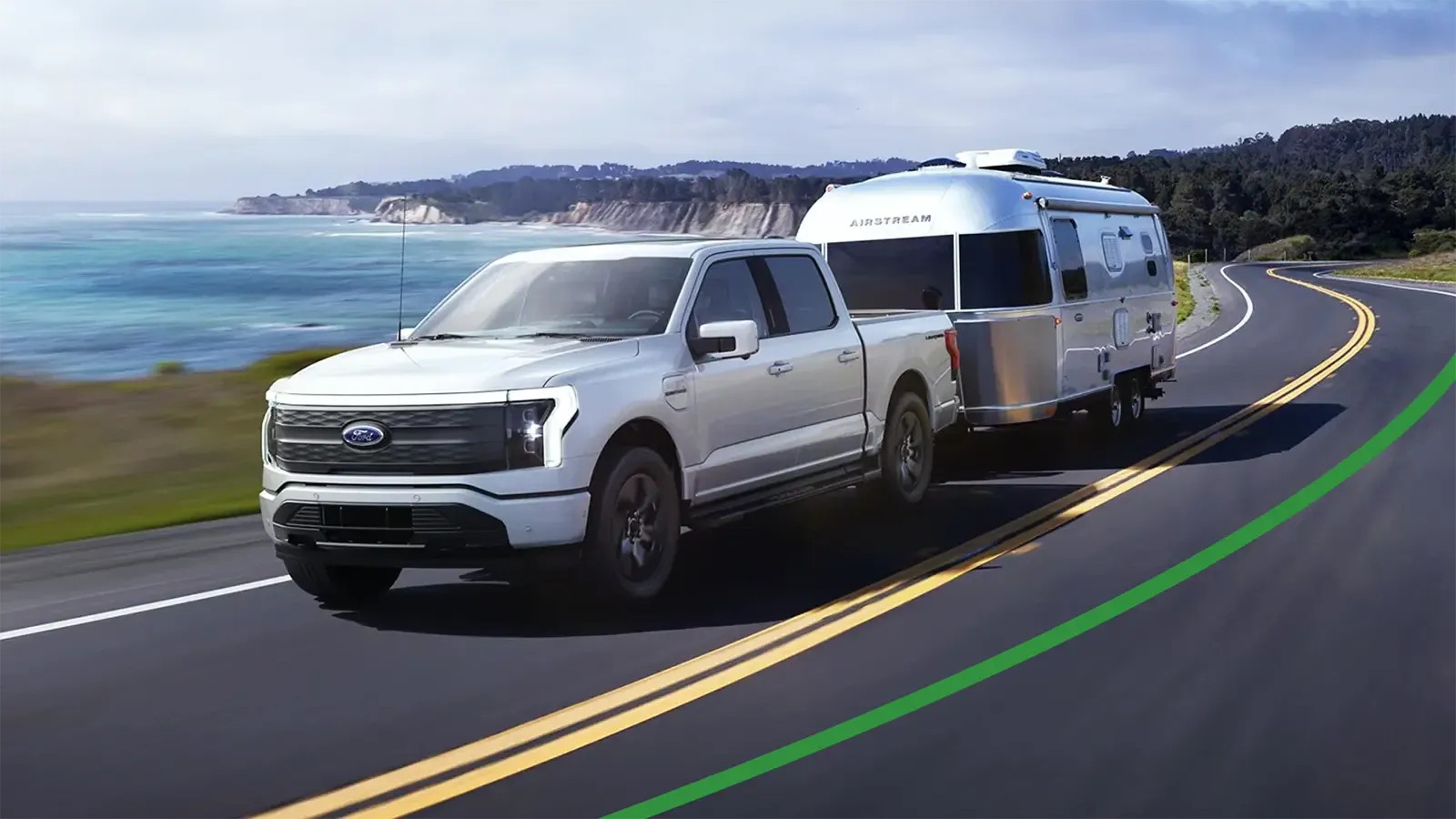 Ford Truck with Airstream trailer driving near water