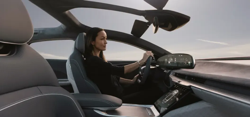 Woman Driving with high tech interior of the Lucid Air