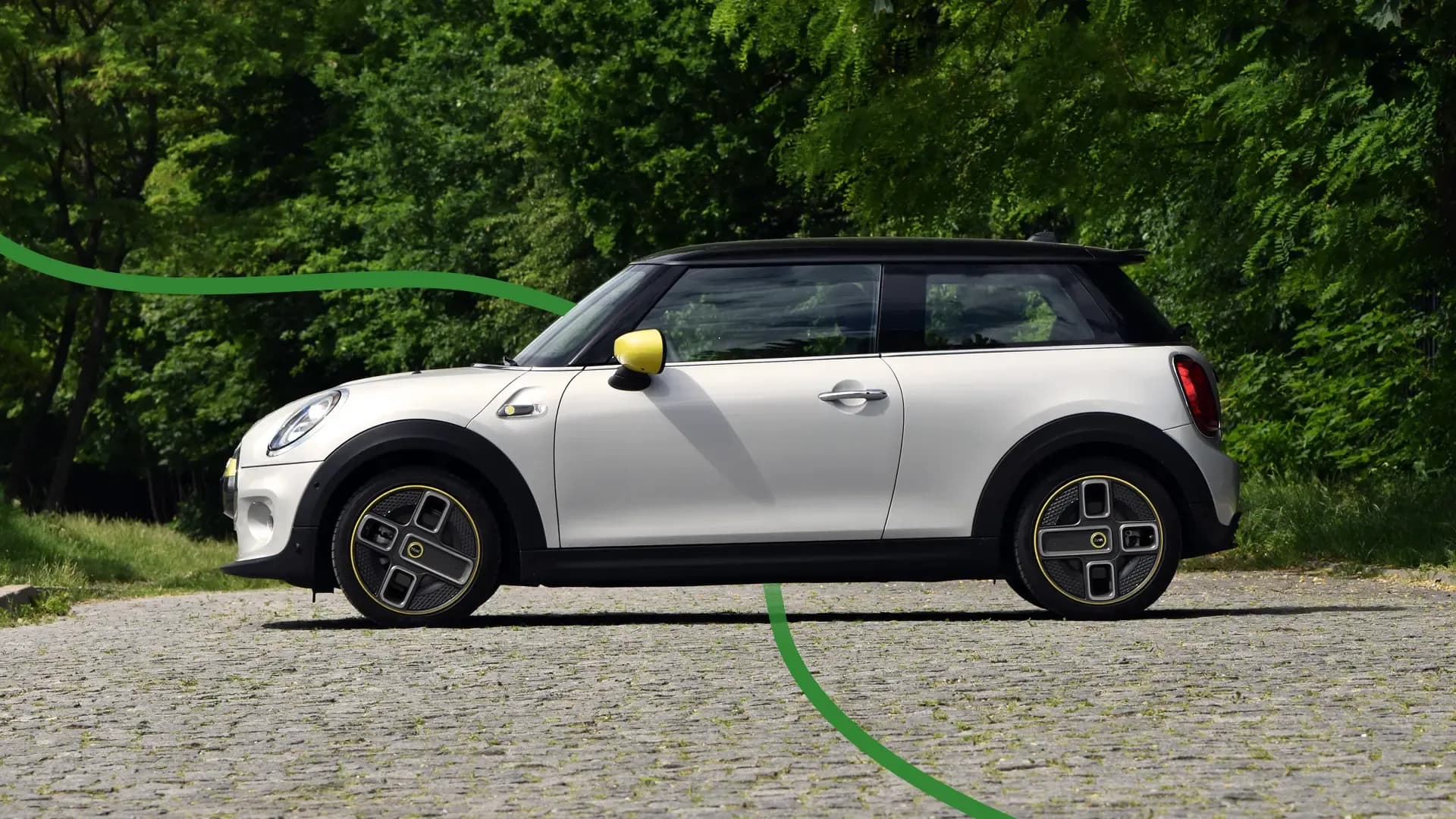 Mini Cooper EV with green backdrop