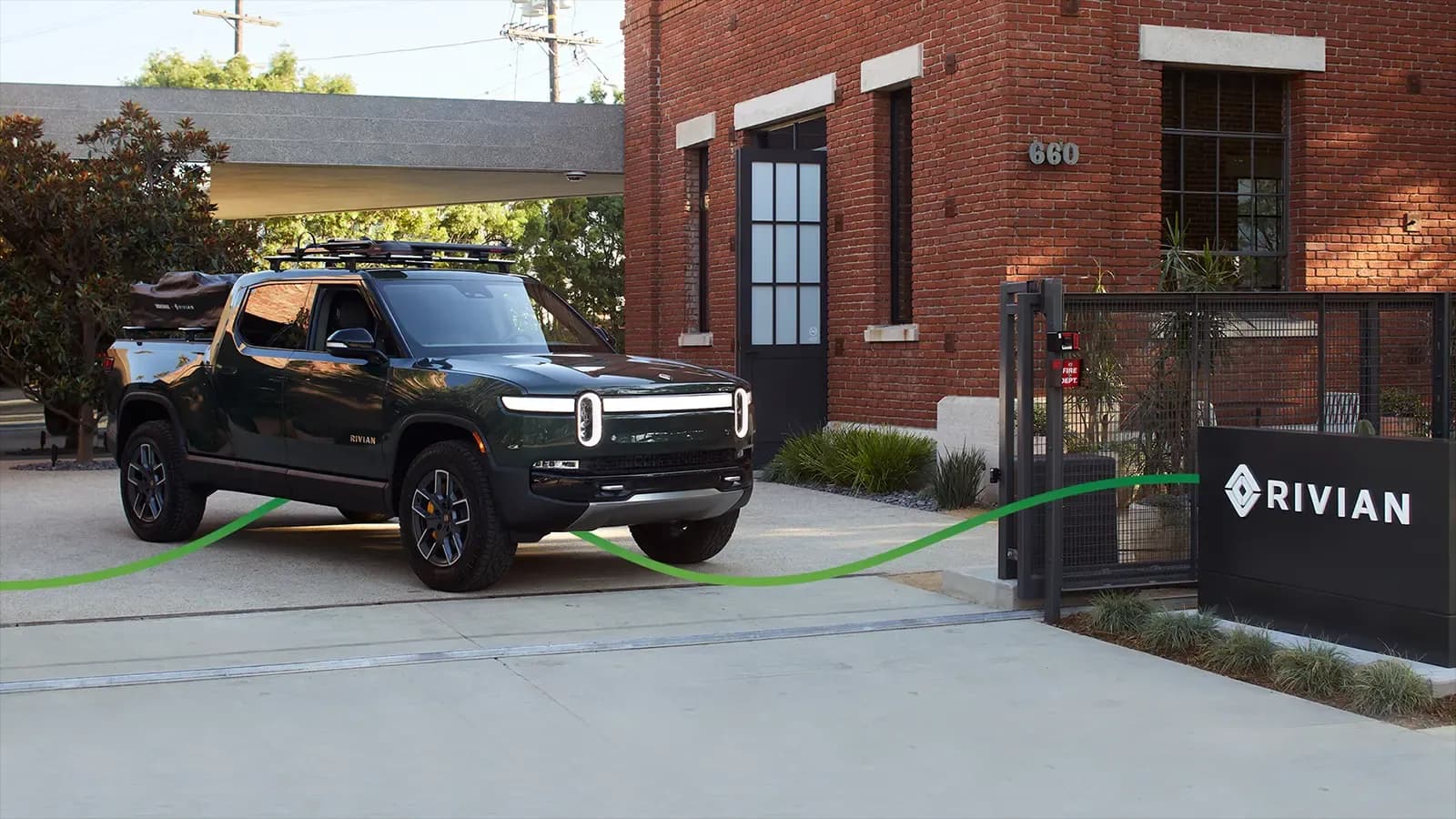 Dark green Rivian R1T parked outside Rivian Headquarters