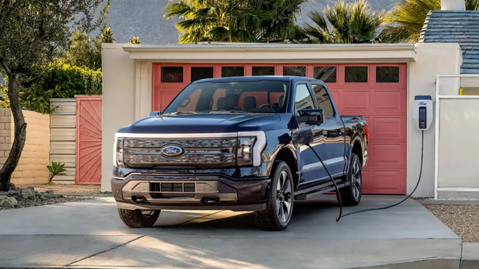 Ford electric truck in driveway plugged in