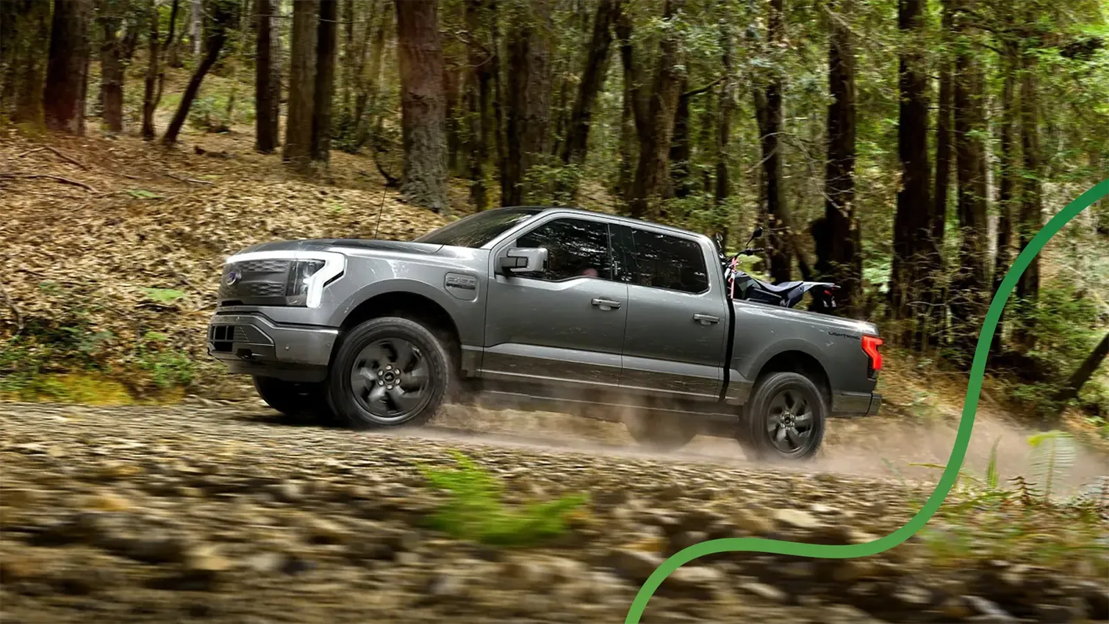 Ford electric truck driving up dirt road