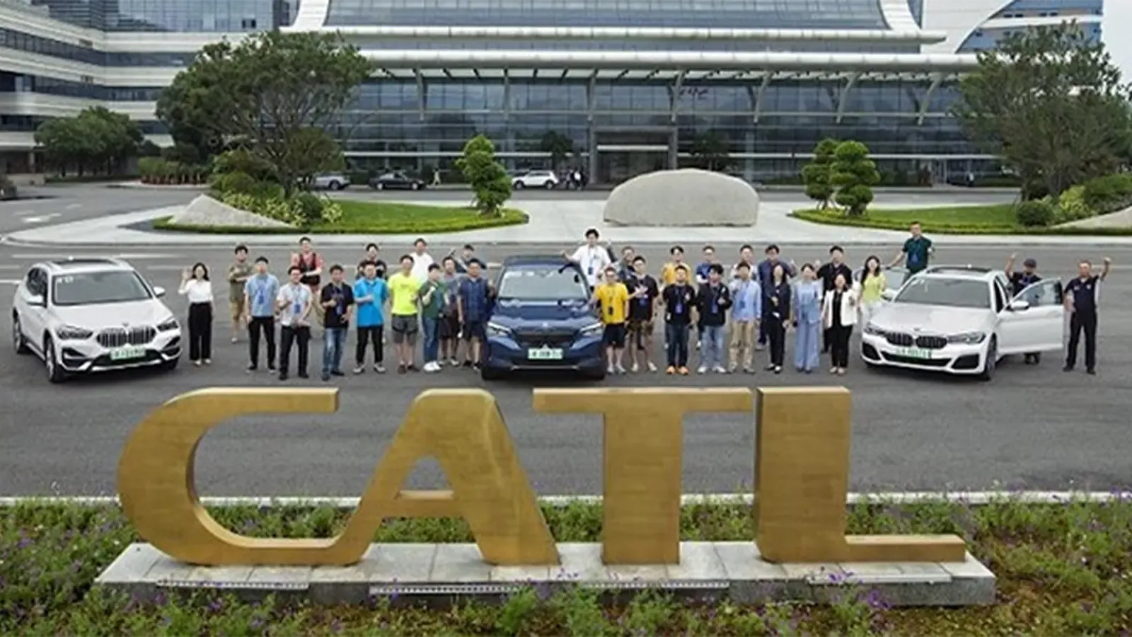 CATL group outside building with three cars