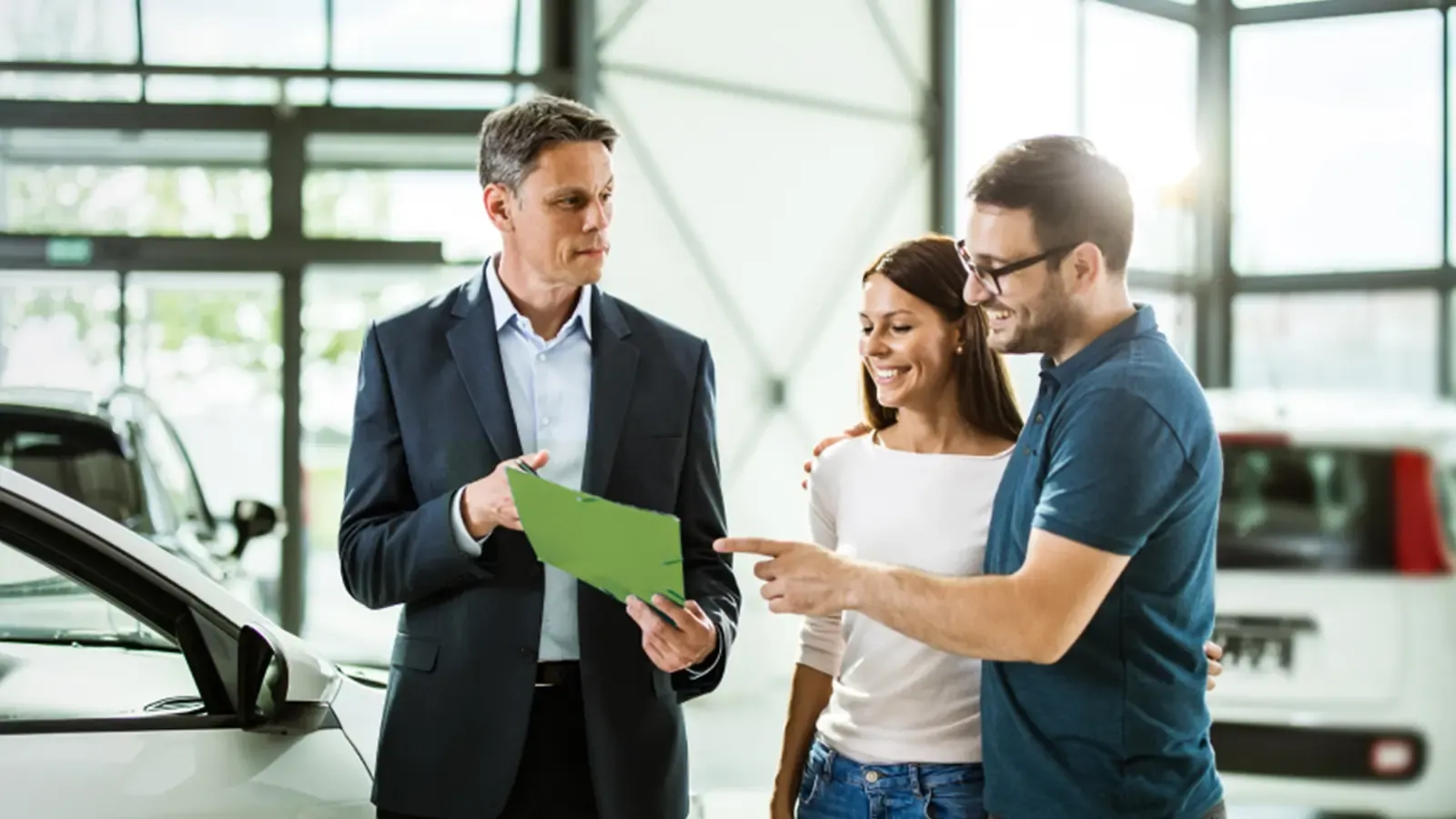 a couple talking with a car salesman