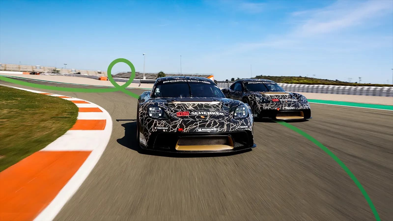 Two Porsche race cars driving on race track with Green Cars wavy line