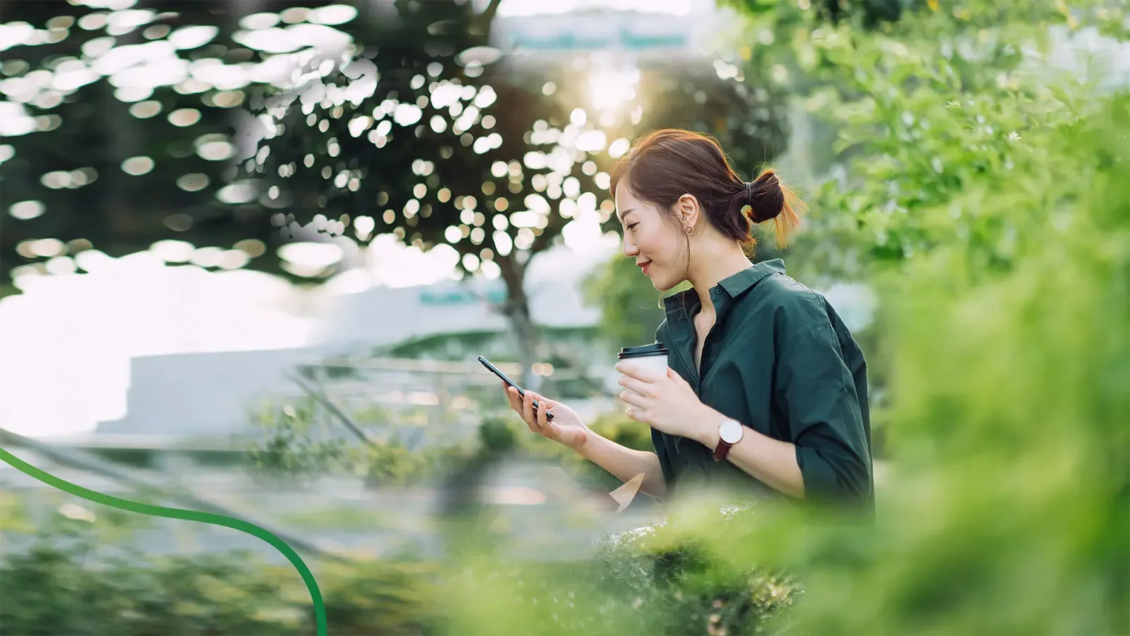 a woman drinking coffee and looking on her phone