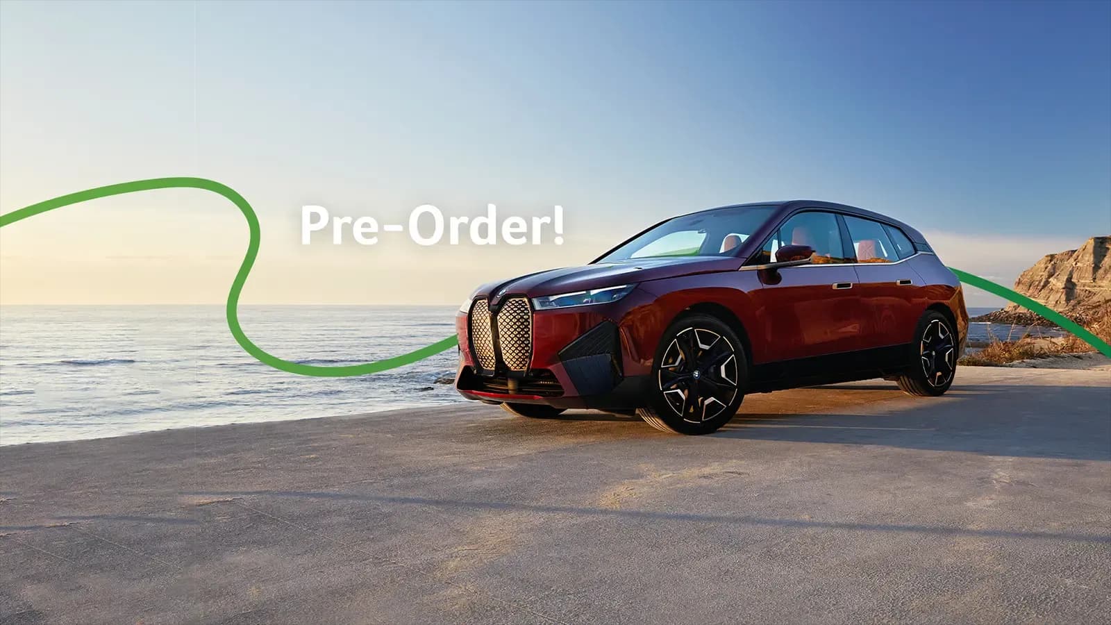 Red BMW electric vehicle, coast-side with "Pre-Order" and Green Cars wavy line