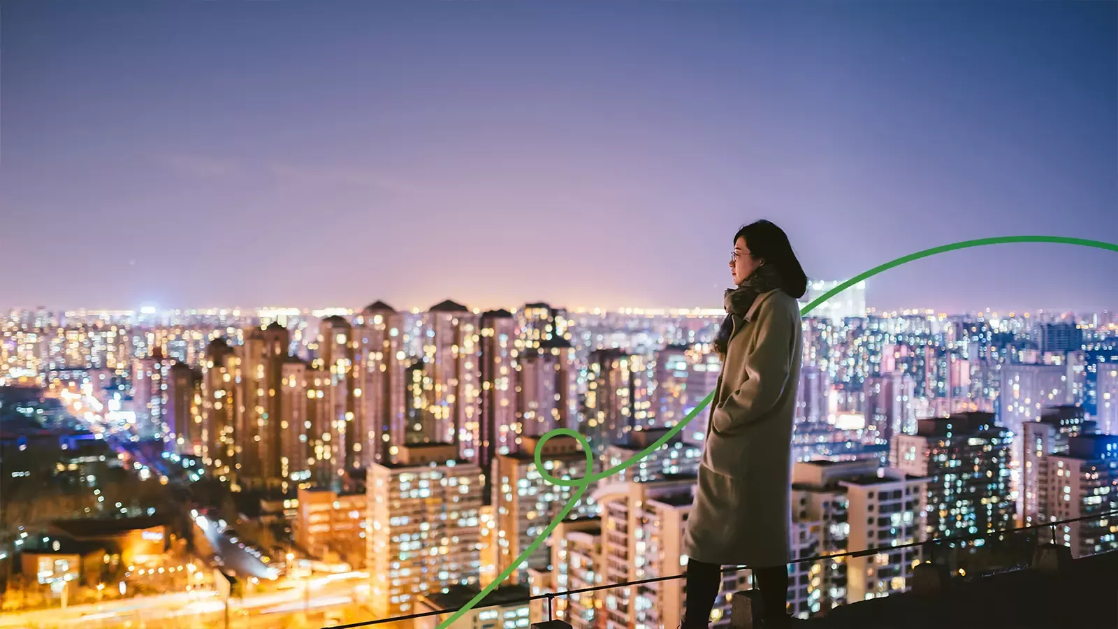 woman looking at city scape at nigh