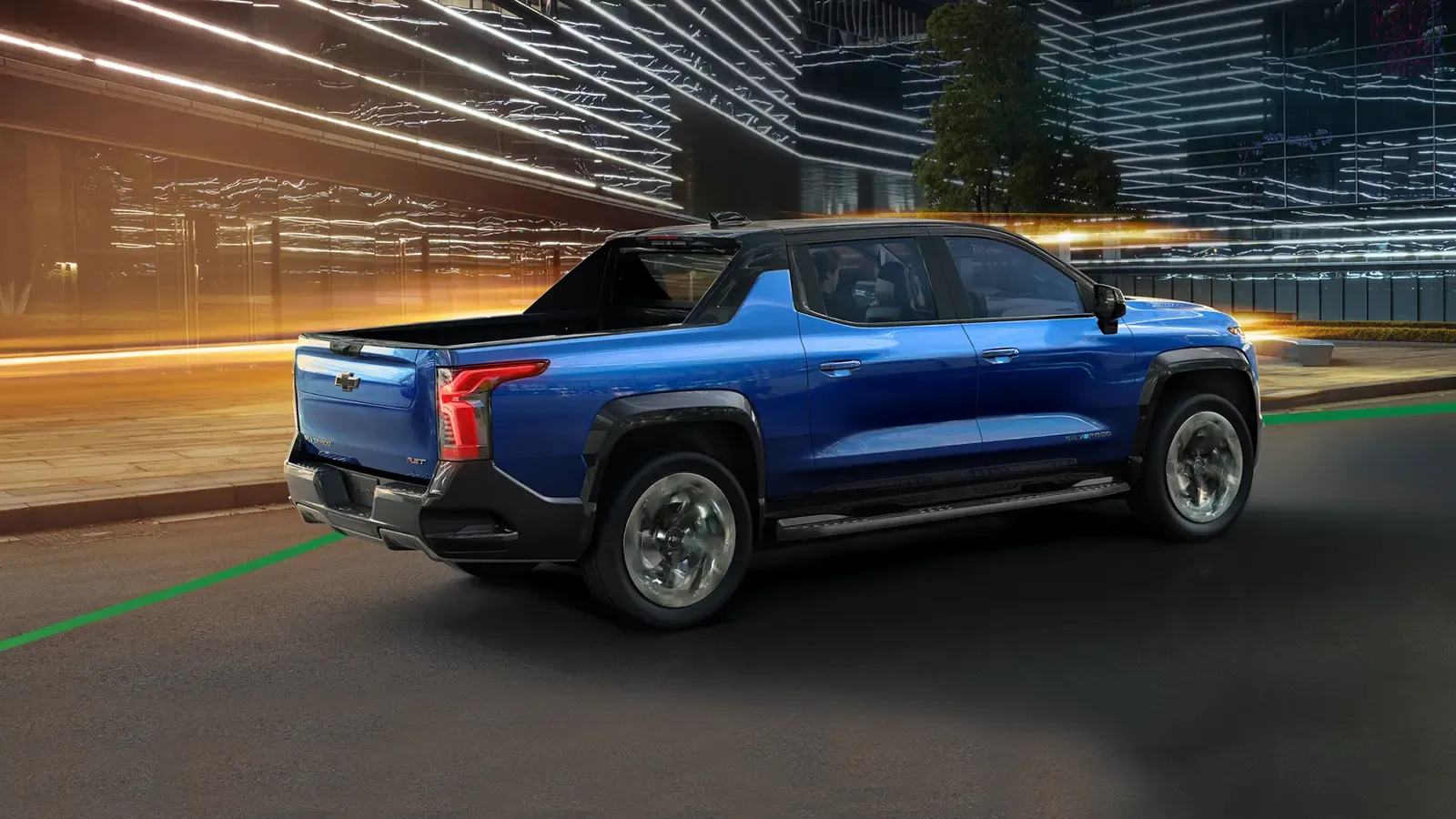 Chevrolet Silverado EV driving through the city at night