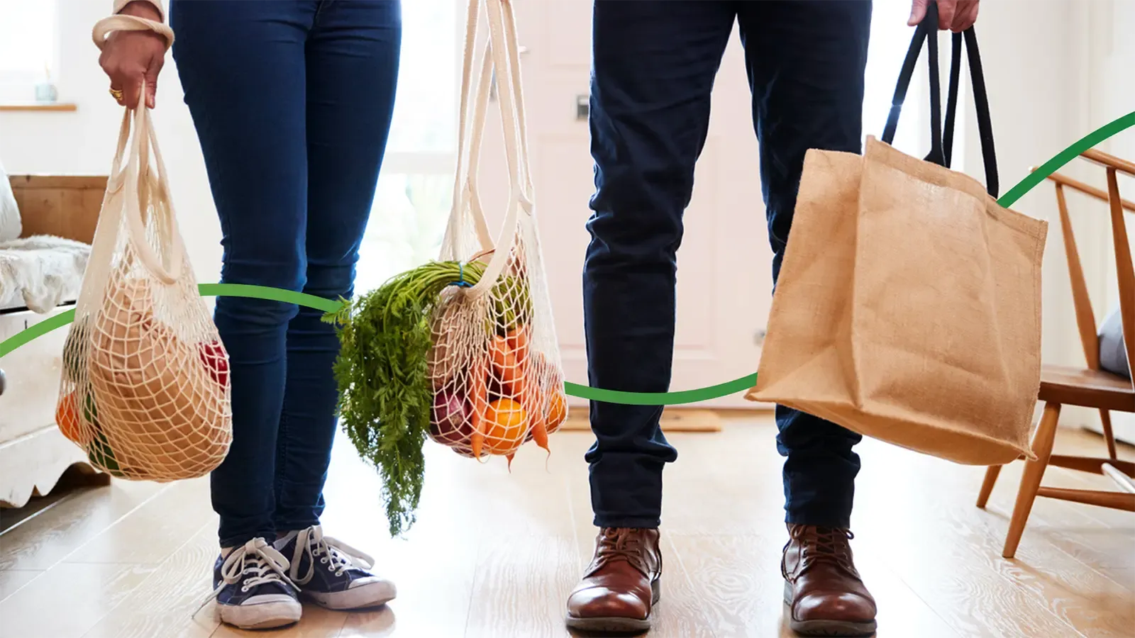2 people holding fresh produce in reusable bags