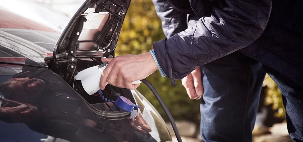 man plugging in vehicle