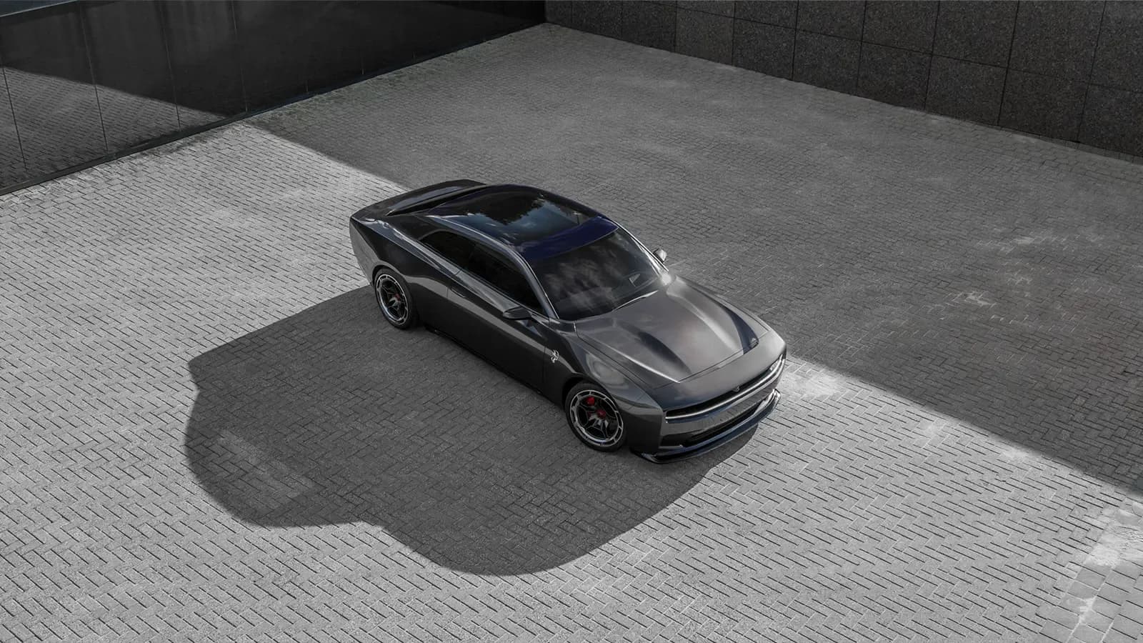an electric dodge charger parked on gray pavement