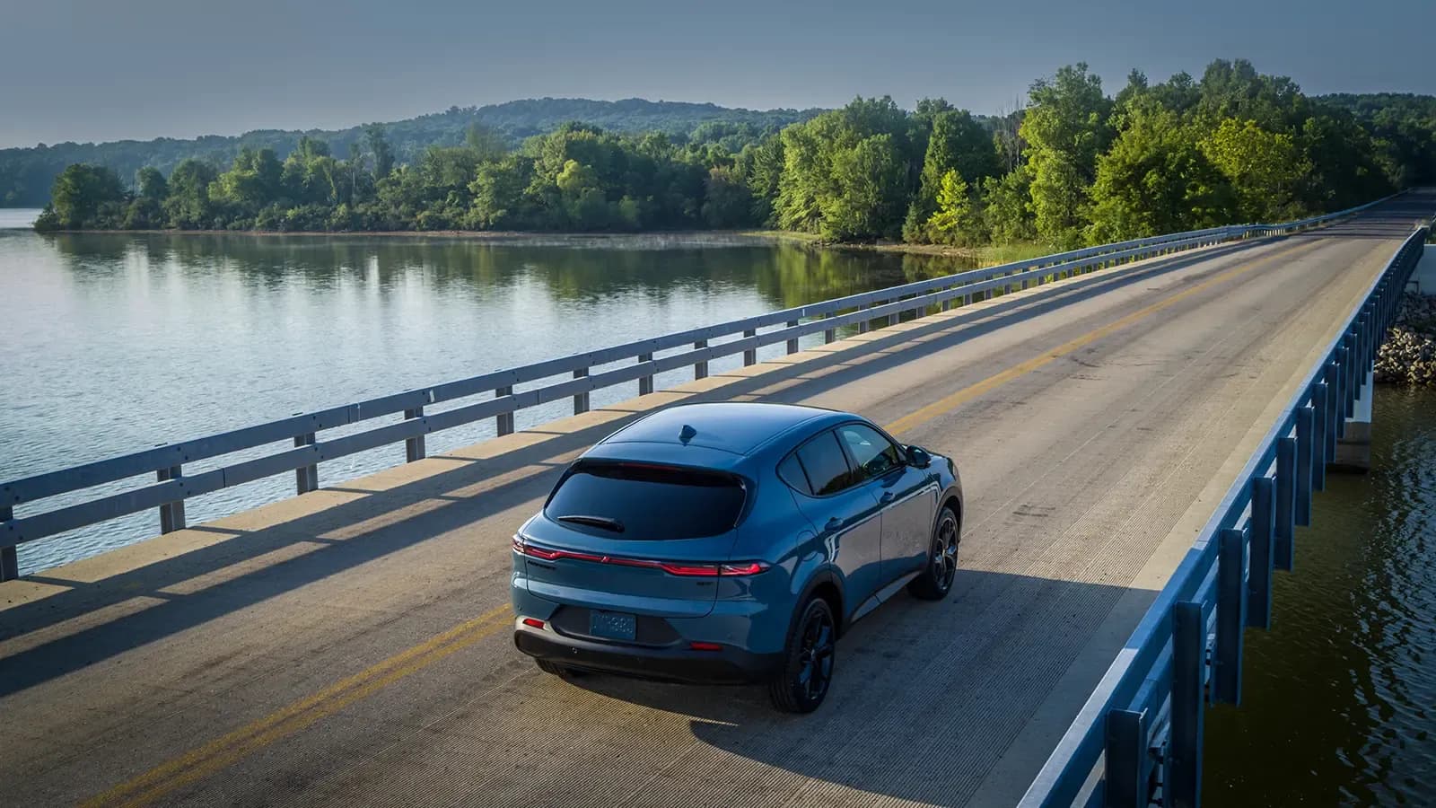 Dodge Hornet driving on road next to body of water