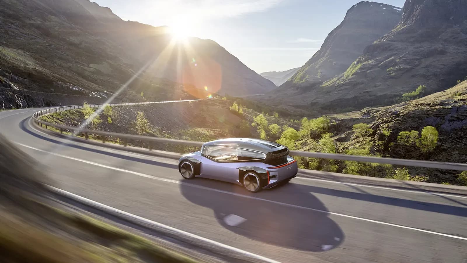 A prototype of Volkwagen's autonomous research vehicle driving on a windy hillside road