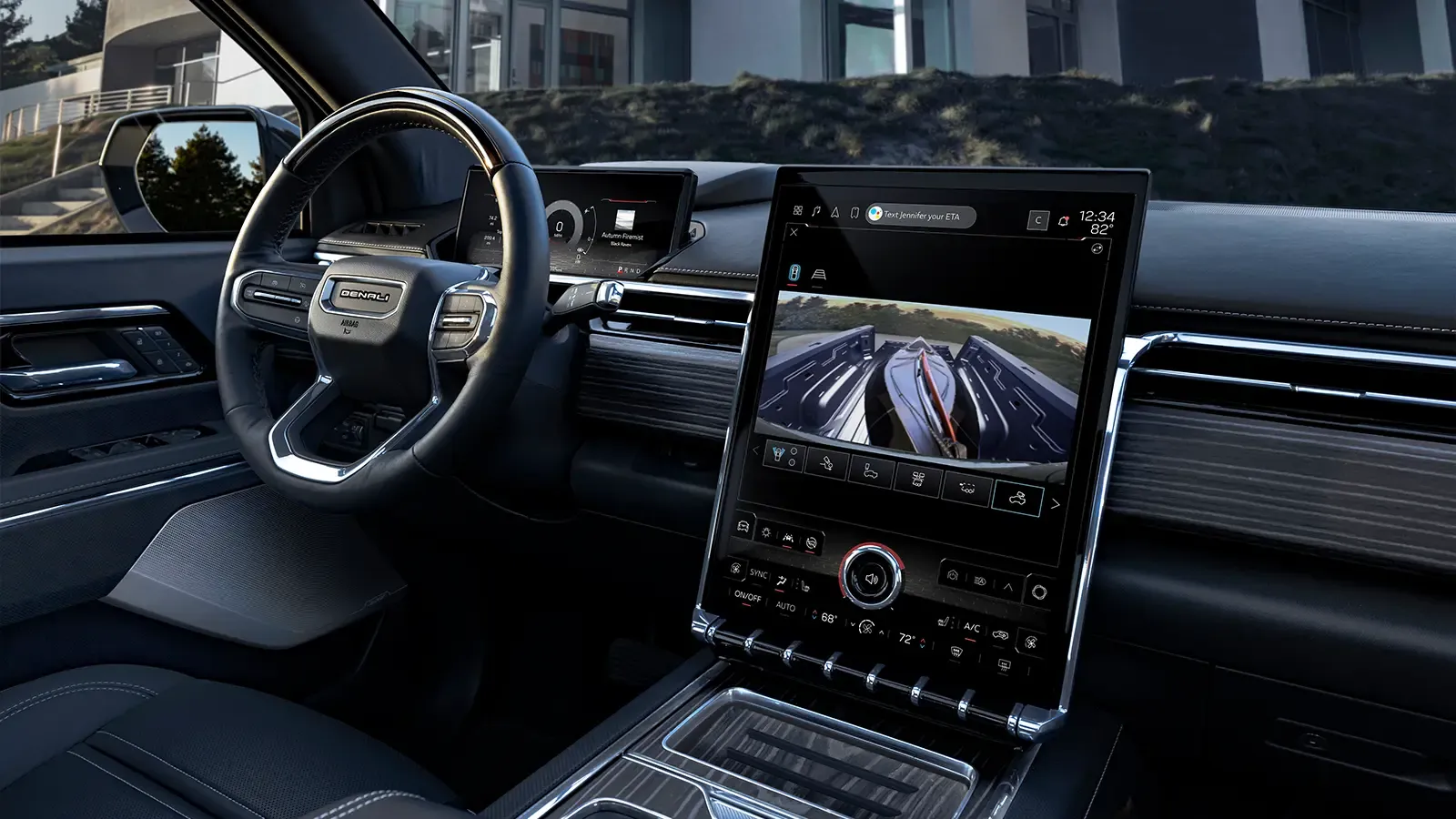 2024 GMC Sierra EV interior Wheel and Tech outside modern house