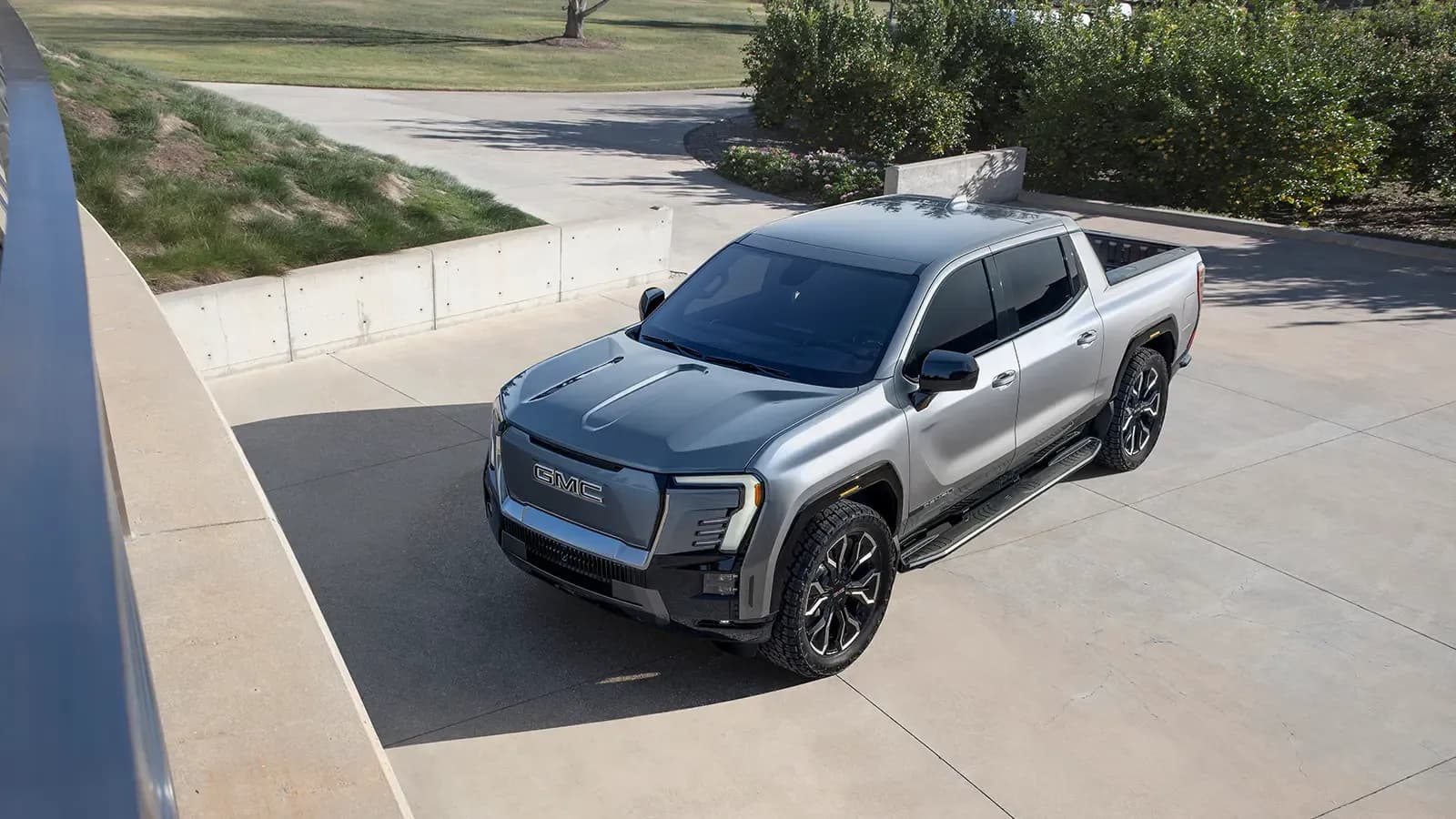 2024 GMC Sierra EV parked outside modern home