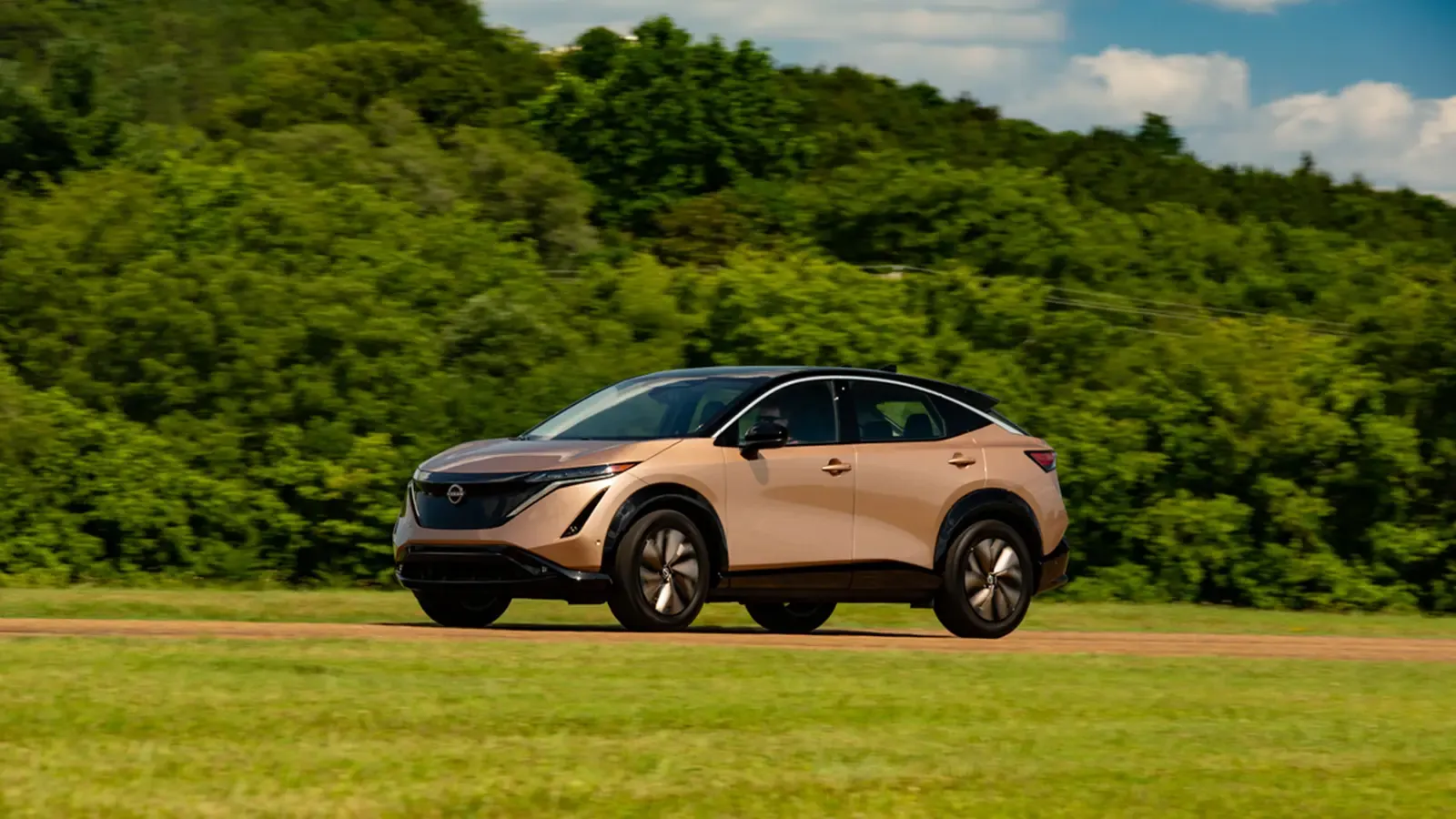 Nissan ARIYA driving on a dirt road