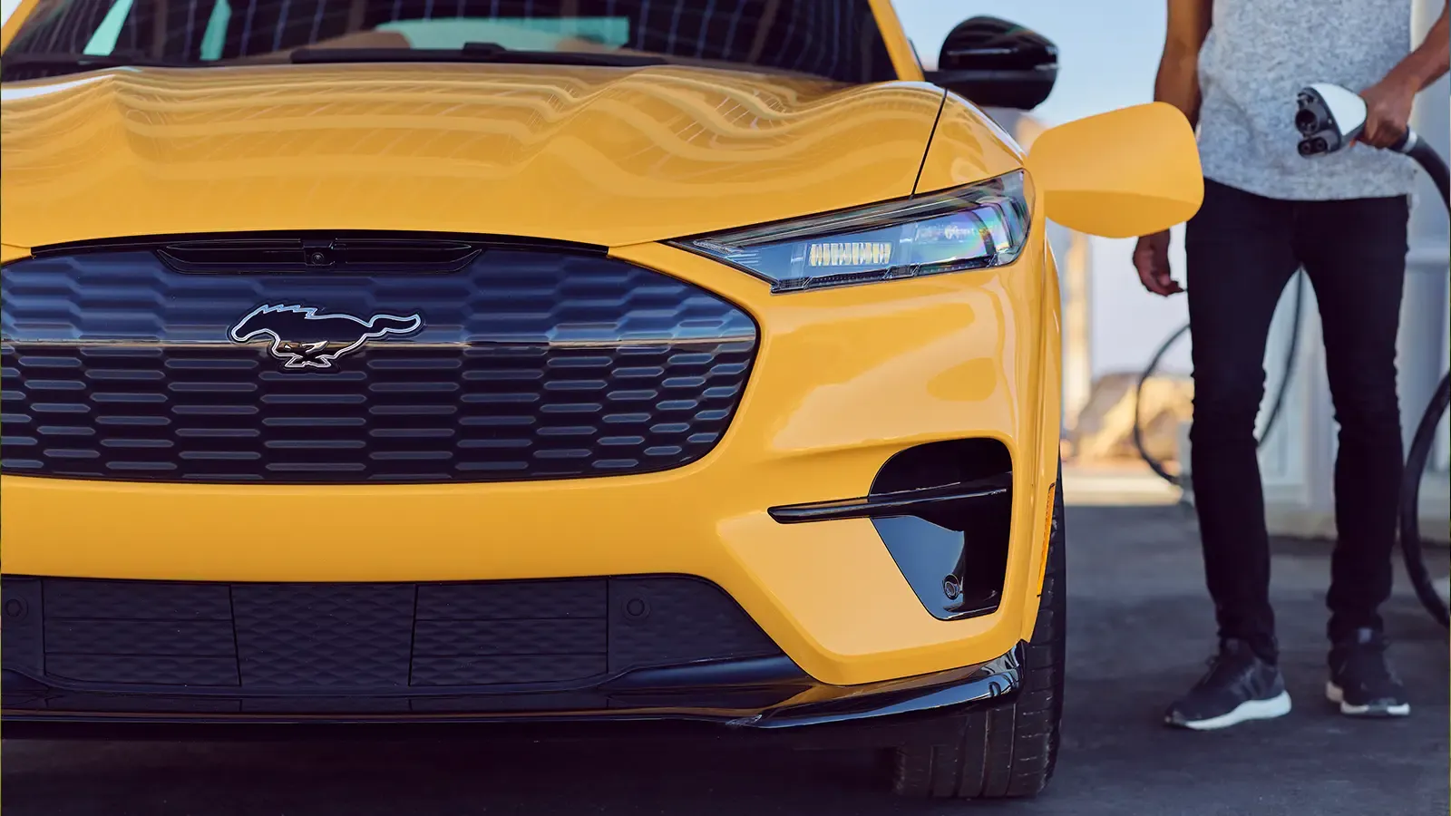 yellow mustang mach-e being charged