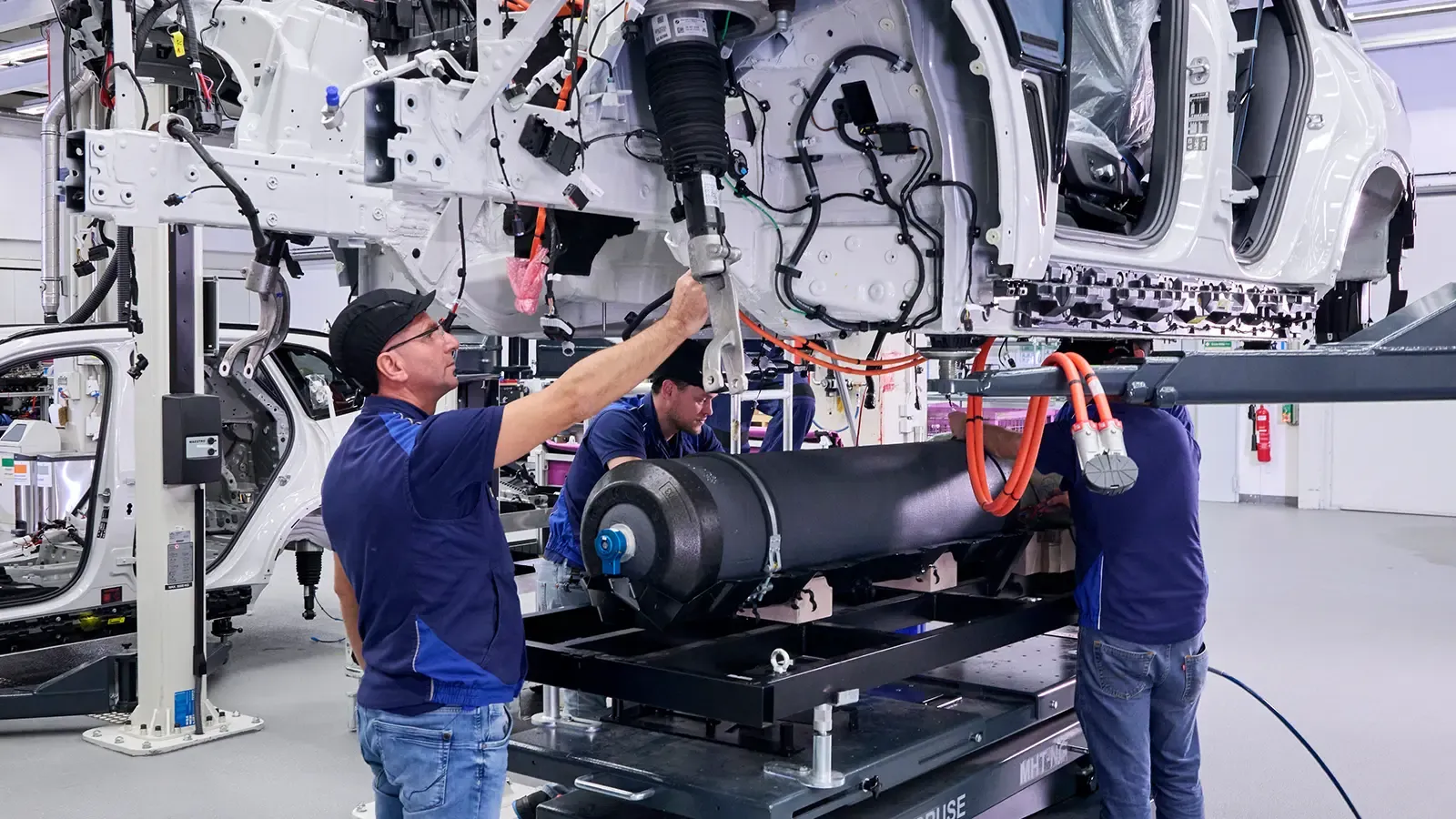 3 men building a BMW X5
