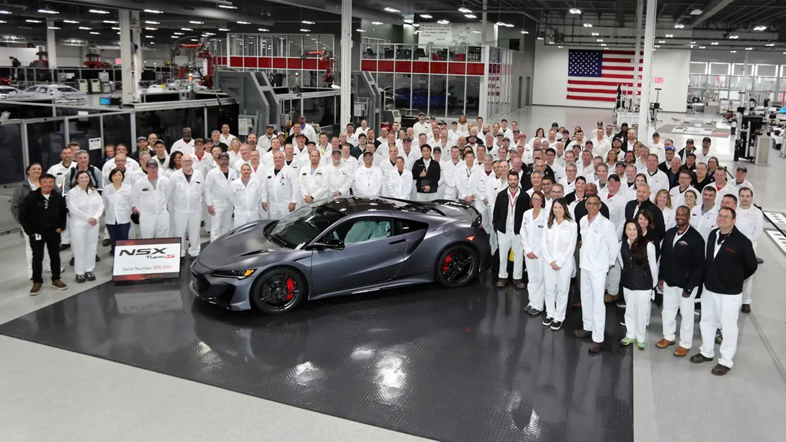 Marysville, OH manufacturing team surrounding car in a factory