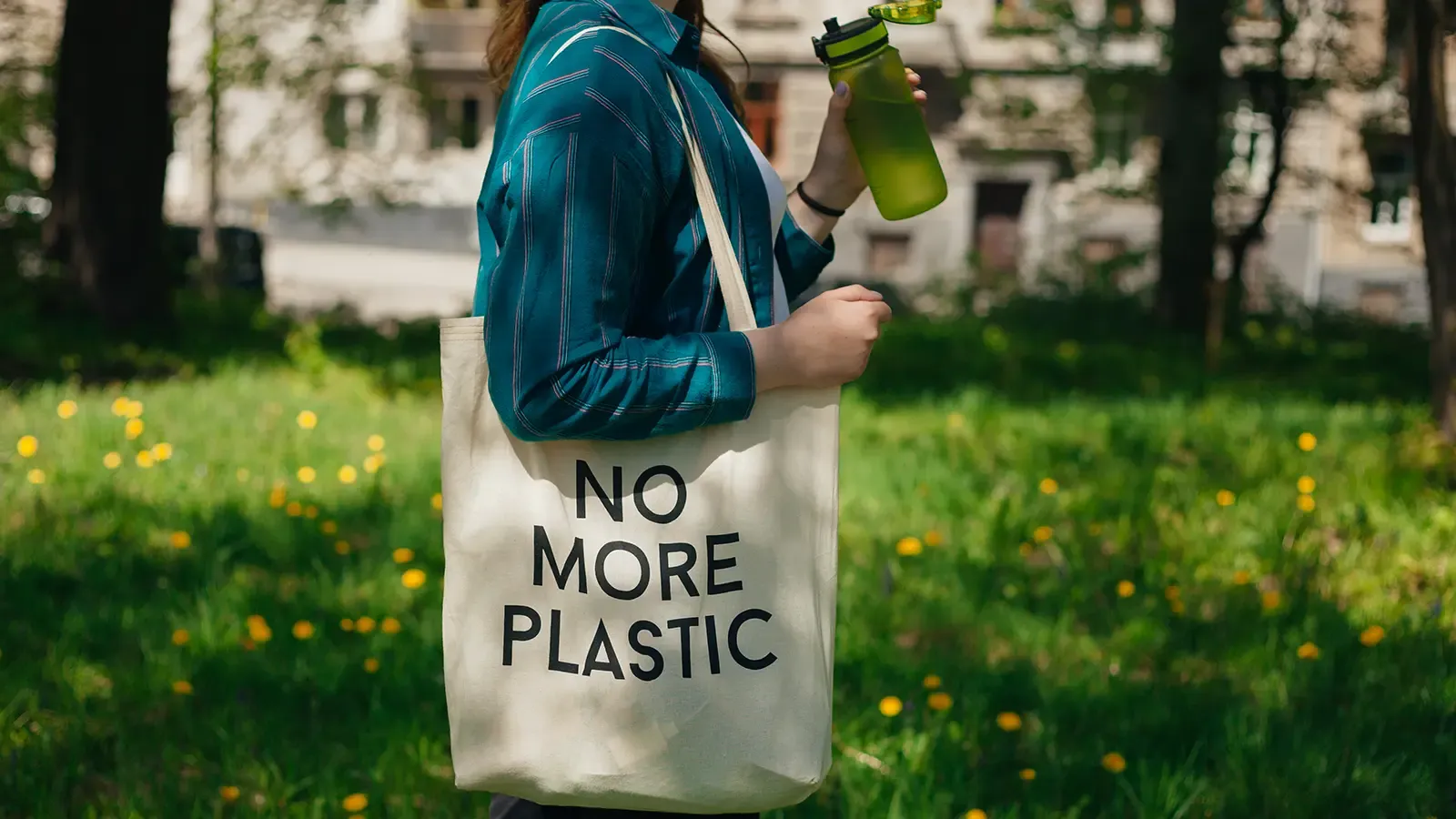 A woman with a reusable bag and water bottle