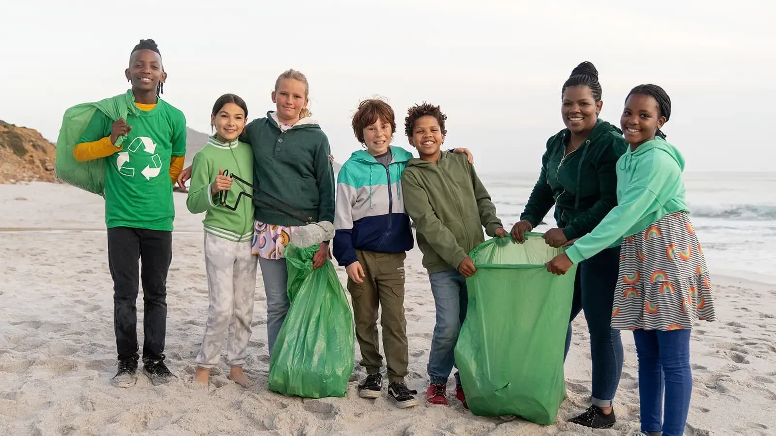 Group of people cleaning up garbage from the beach