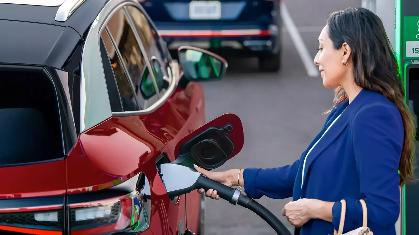 Woman charging Red electric car