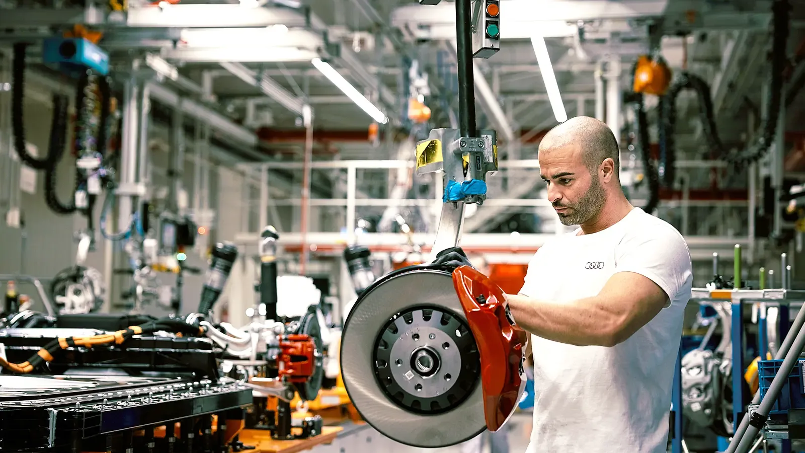Man working on car components in factory