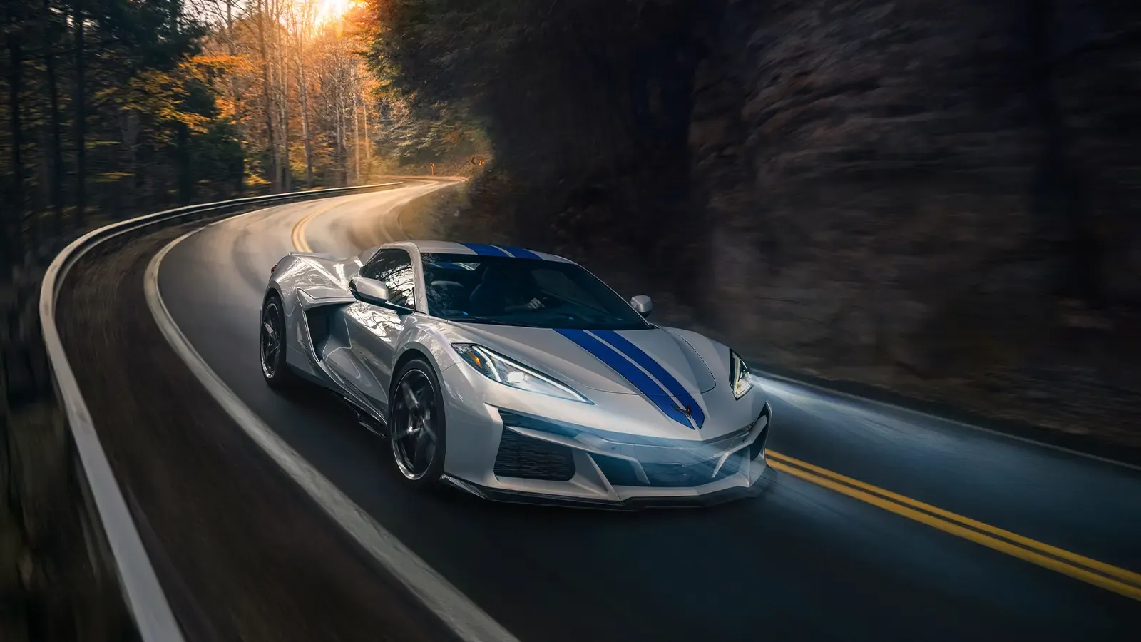 Corvette driving around country highway corner