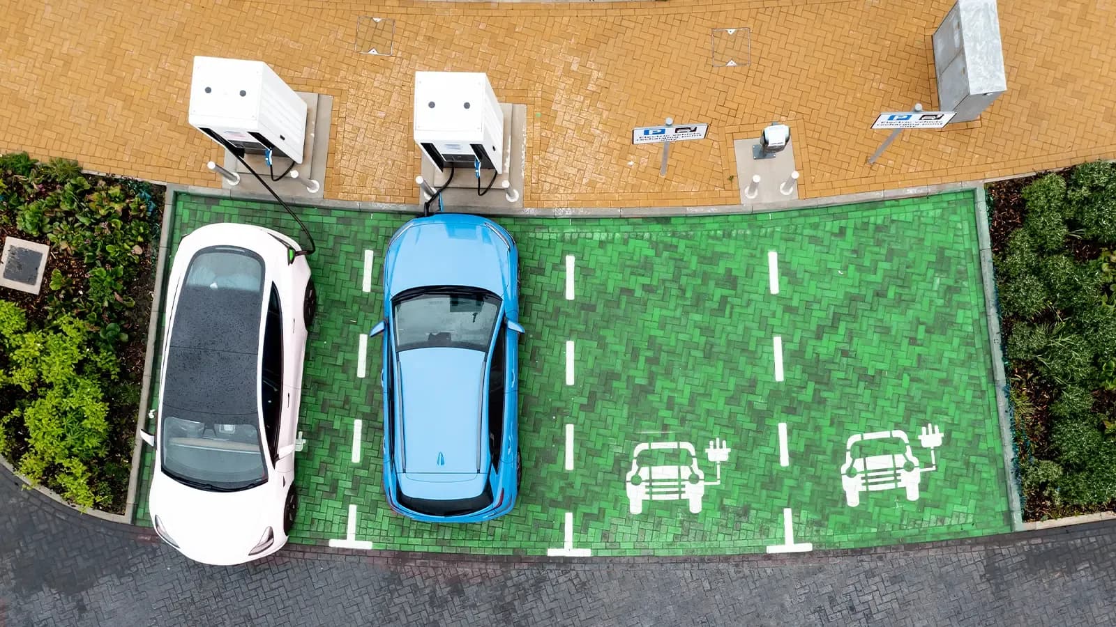 Two cars charging at a public electric car charging station