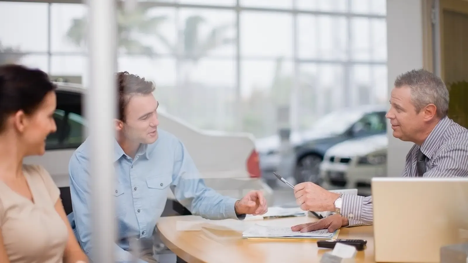 Couple making a deal at a car dealership