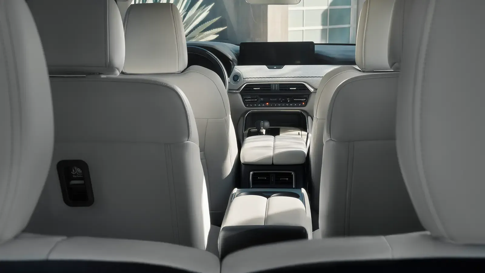 Interior shot of Mazda CX-90 from the backseat perspective.