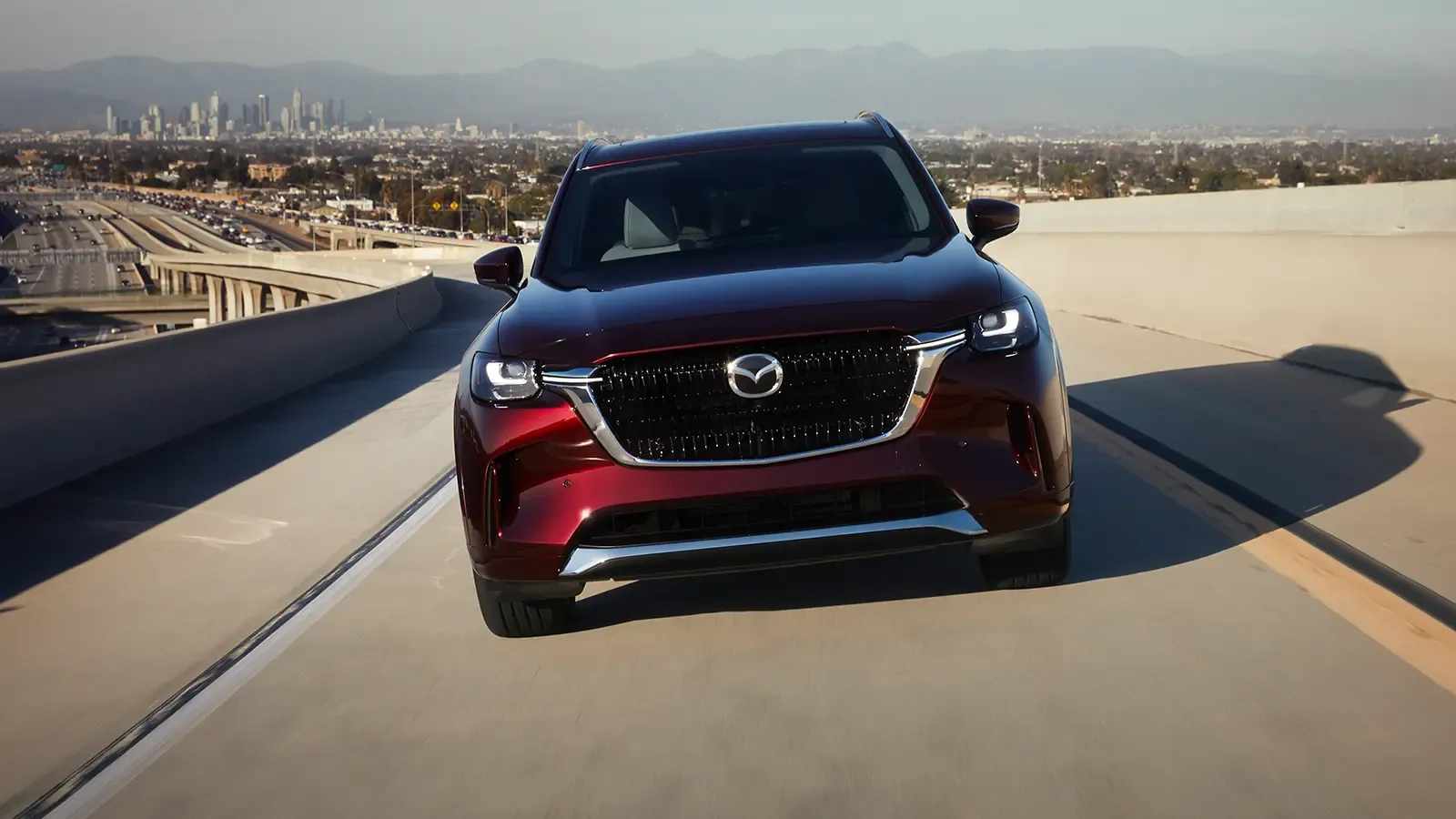 Front exterior of Mazda CX-90 driving on highway