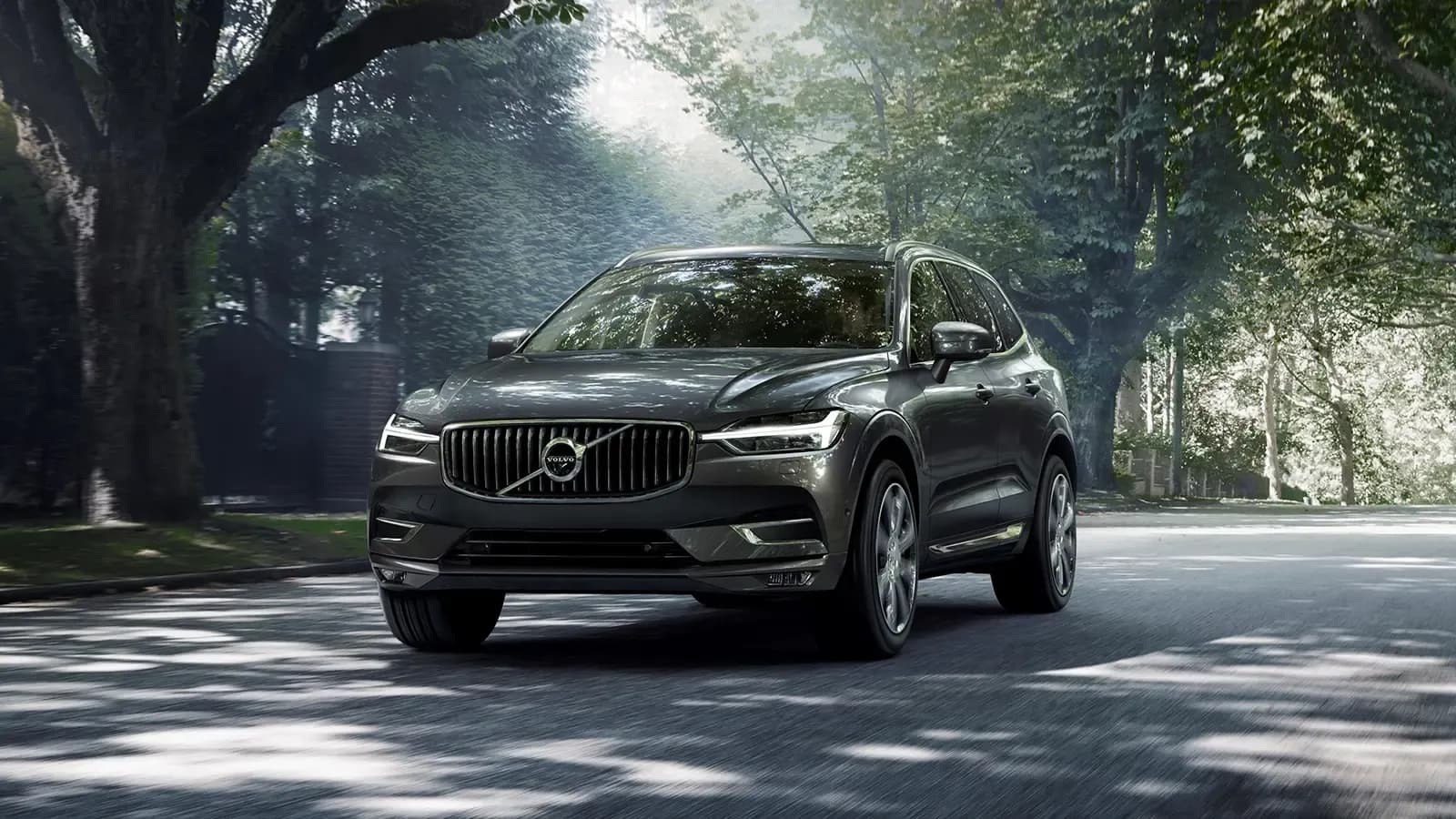 Volvo XC60 T8 Recharge in a lush green neighborhood