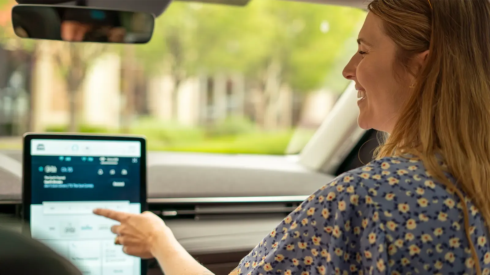 Woman setting navigation in an electric car
