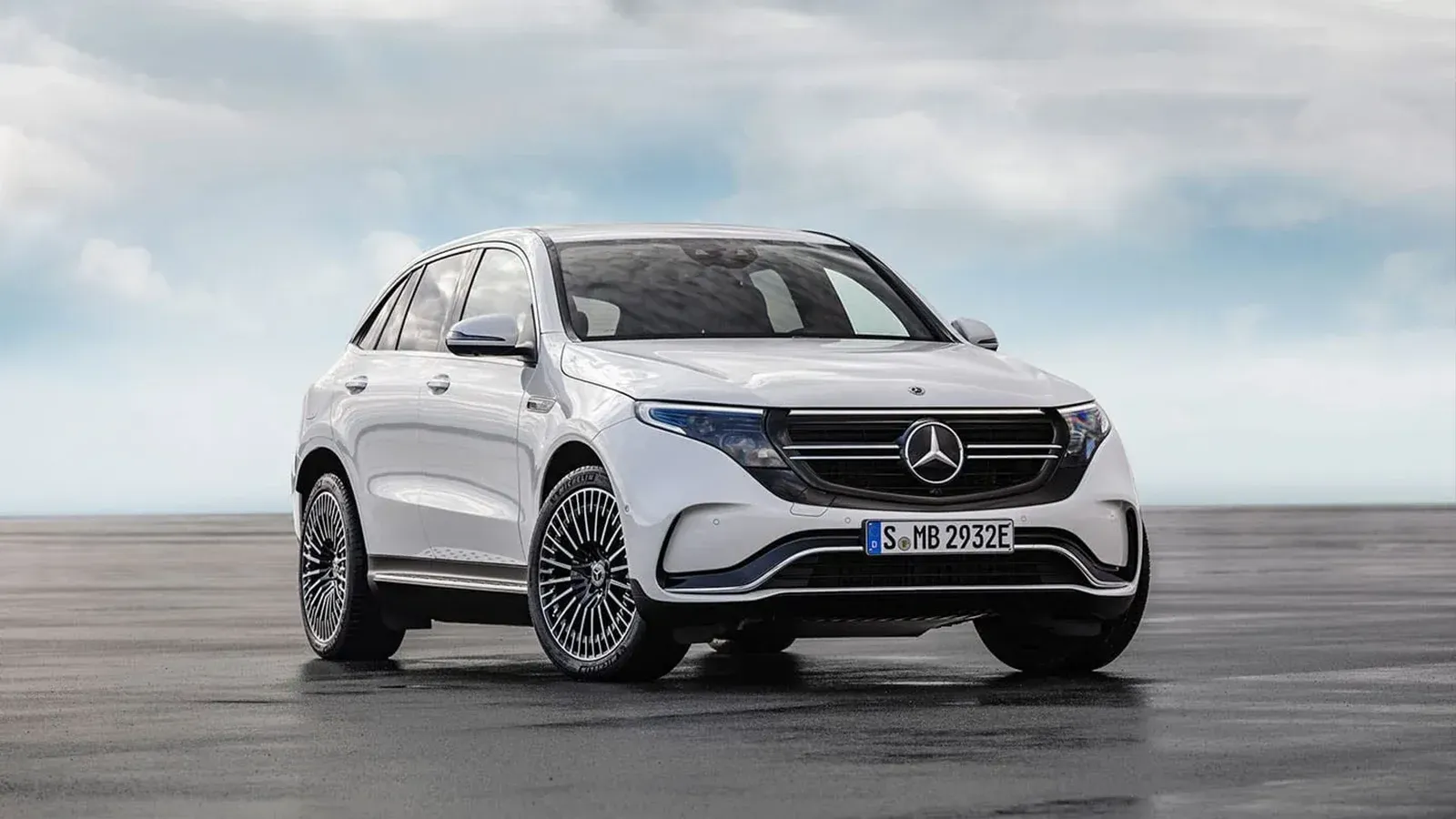 Mercedes-Benz EQC 400 parked with blue and cloud sky background