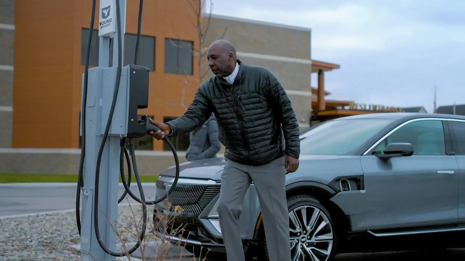 man using charging station for his car